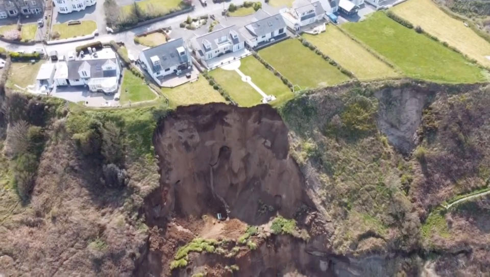 A giant landslide slid onto a beach today - only minutes after people had walked on the sand.

Large parts of clifftop gardens - and even a wooden bench - were carried onto the beach in the fall.
 
Police were urging people to stay away from the landslide at Nefyn near Pwllheli, North Wales, in case of more falls.

Hairdress Christian Pilling said: 