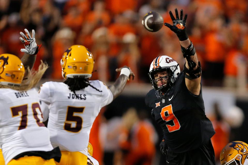 OSU defensive end Brock Martin (9) puts pressure on Arizona State quarterback Emory Jones (5) on Sept. 10.