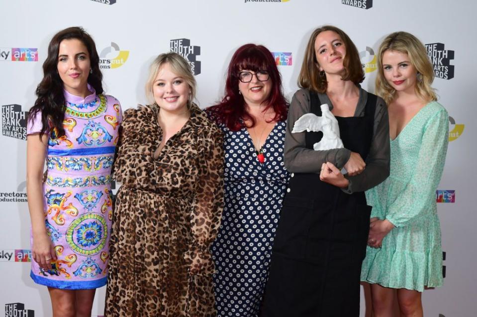 the derry girls cast standing next to one another and smiling for a photo