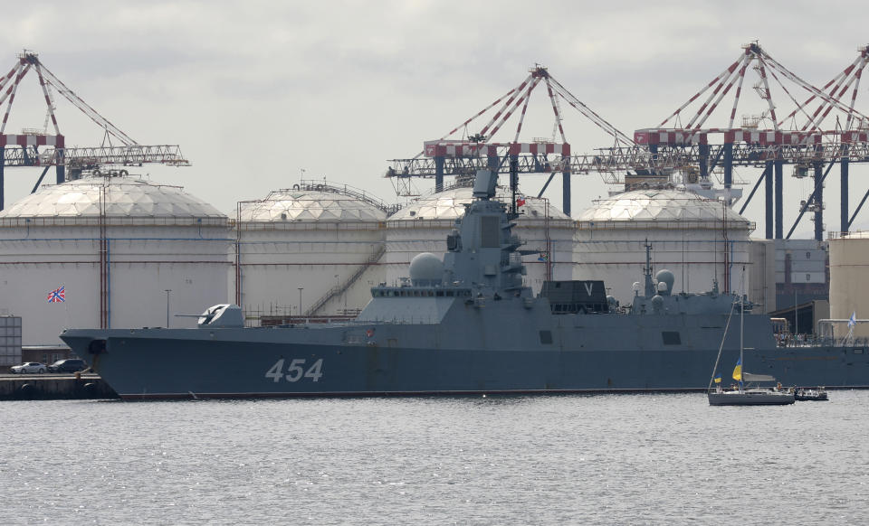 People on a yacht, right, protest against the Russian frigate Admiral Gorshkov docked in the Cape Town harbour South Africa, Tuesday, Feb. 14, 2023 en route to the South African east coast to conduct naval exercises with the South African and Chinese Navy. The exercise is set to begin Friday Feb. 17, 2023, a demonstration of the countries' close ties amid Russia's war in Ukraine and China's tense relationship with the West. (AP Photo/Nardus Engelbrecht)