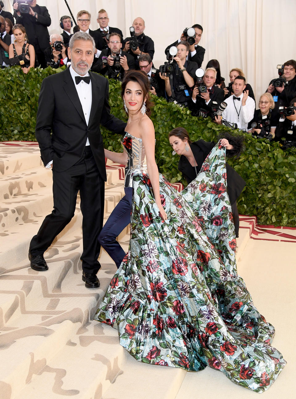 <p>George Clooney and Amal Clooney set the tone for the night in their classy get-ups. Amal stole the show in a satin Richard Quinn jumpsuit, with a flowing floral train. Photo: Getty Images </p>