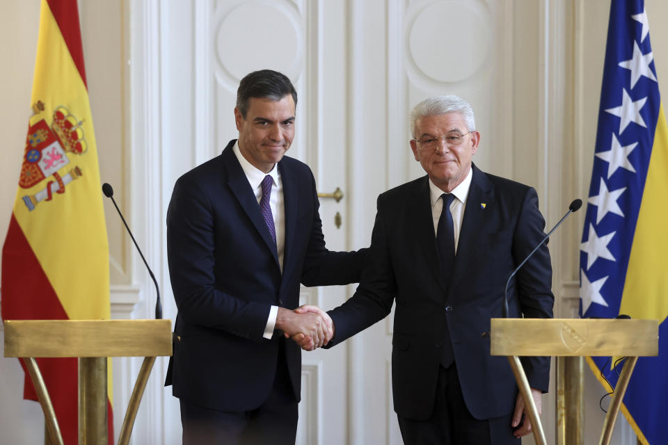 Spanish Prime Minister Pedro Sanchez, left, shakes hands with the member of the Bosnian presidency Sefik Dzaferovic after a press conference in Sarajevo, Bosnia, Saturday, July 30, 2022. (AP Photo/Armin Durgut)