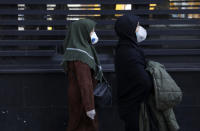 People walk as they wear masks in downtown Tehran, Iran, Thursday, Feb. 27, 2020. Amid fear and uncertainty caused by the spread of a new virus, Iranians are taking extra caution to avoid getting infected, as authorities canceled Friday prayers in Tehran, Qom and other cities. (AP Photo/Vahid Salemi)
