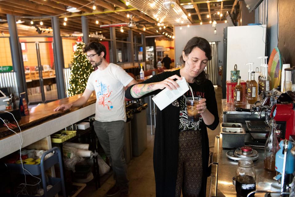 Jitterbug Beverage Co. co-owner Ari Booth makes one of her signature cold coffee beverages at her new location on 12th Avenue on Friday, while her husband and company co-owner, Barrett Colhoun, manages the orders. Jitterbug is sharing the space with The Magnolia restaurant.
