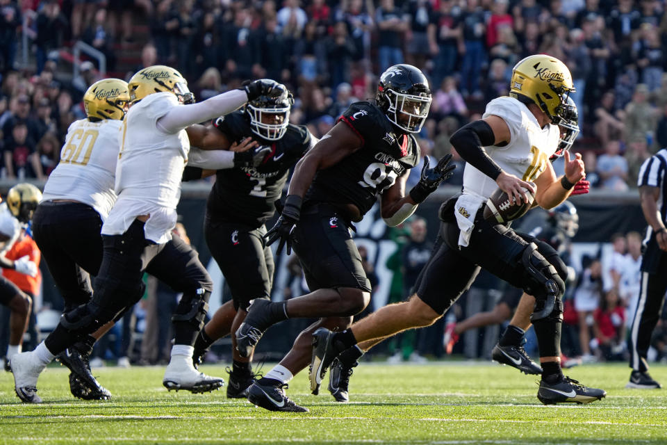 UC's defense goes after UCF's quarterback John Rhys Plumlee (10) during the UC vs. UCF game at Nippert Stadium on Saturday November 4, 2023