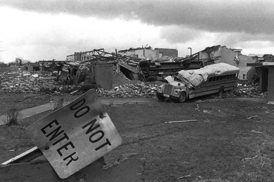 FILE – School buses rest April 5, 1974, on the remains of the high school where they were tossed in Xenia, Ohio, by a tornado that went through the town. The deadly tornado killed 32 people, injured hundreds and leveled half the city of 25,000. Nearby Wilberforce was also hit hard. As the Watergate scandal unfolded in Washington, President Richard Nixon made an unannounced visit to Xenia to tour the damage. Xenia’s was the deadliest and most powerful tornado of the 1974 Super Outbreak. (AP Photo, file)