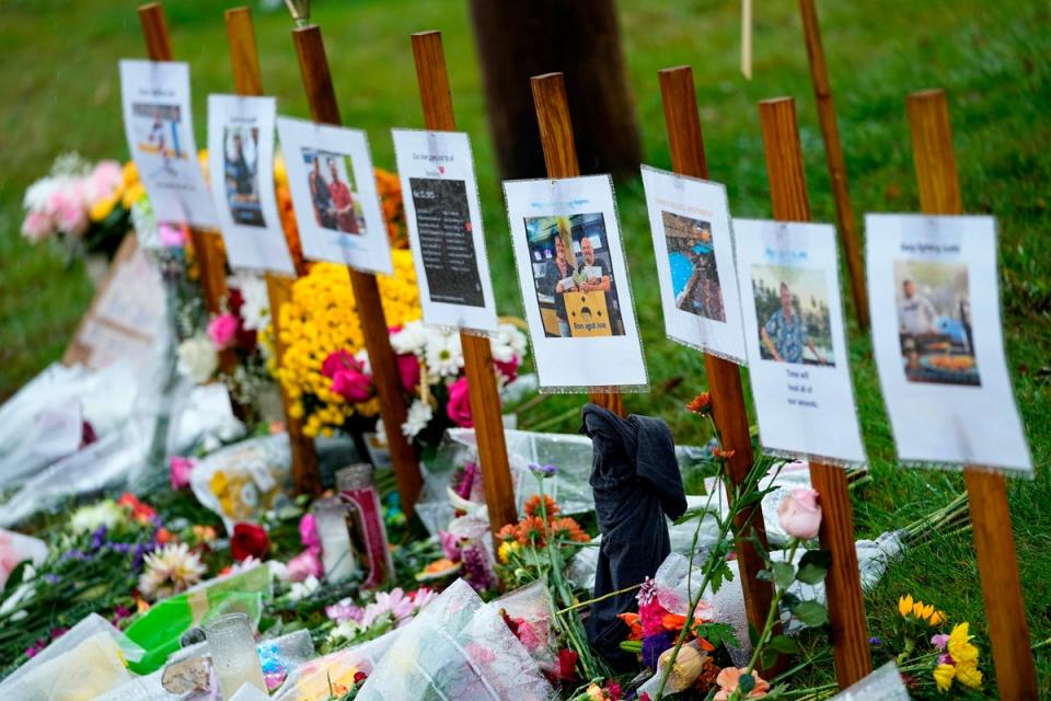 Rain soaked memorials for those who died in a mass shooting sit along the roadside by Schemengees Bar & Grille (Copyright 2023 The Associated Press. All rights reserved)