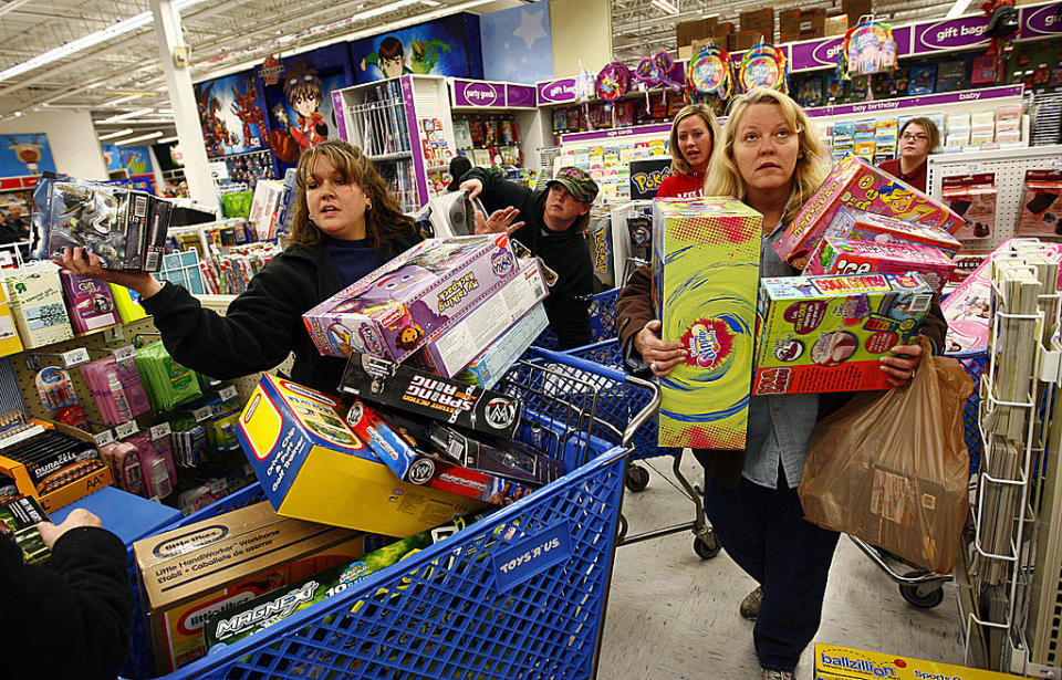 FORT WORTH, TX -  NOVEMBER 27:  Shoppers Jeri Hull (L) and Karen Brashear (R) wait in line while shopping at Toys"R"Us during the Black Friday sales event on November 27, 2009 in Fort Worth, Texas.  Toys"R"Us stores nationwide opened at midnight Thursday, November 26, providing shoppers access to its Black Friday deals five hours earlier than ever before.   According to the National Retail Federation, a trade organization, as many as 134 million people, 4.7% more than last year, will shop this Friday, Saturday or Sunday. (Photo by Tom Pennington/Getty Images)