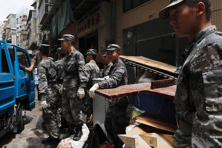 People’s Liberation Army (PLA) soldiers clean debris after Typhoon Hato hits in Macau, China August 25, 2017. REUTERS/Tyrone Siu