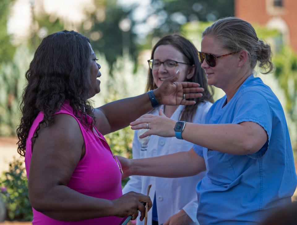 After speaking, Jeannine Lee Lake, candidate for U.S. Congress, left, gets hugs from other speakers during the Reproductive Justice Rally, Wednesday, June 29, 2022 on the IIUPUI campus. 