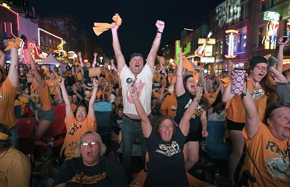 Nashville Predators fans on Lower Broadway celebrate after their team scores its first goal against Pittsburgh Penguins during Game 3 of the Stanley Cup final in Nashville June 3, 2017.