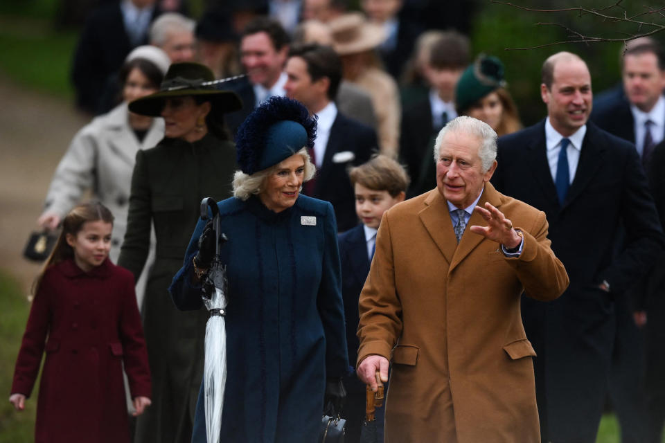 Britain's King Charles III (R) and Britain's Camilla, Queen Consort (L) wave to members of the public as they arrive for the Royal Family's traditional Christmas Day service at St Mary Magdalene Church in Sandringham, Norfolk, eastern England, on December 25, 2022. (Photo by Daniel LEAL / AFP) (Photo by DANIEL LEAL/AFP via Getty Images)
