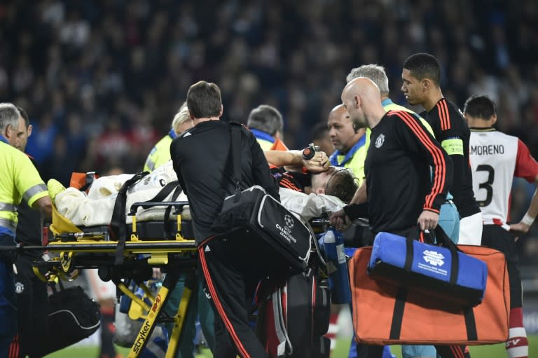 Manchester's Luke Shaw leaves the field after being injured during the UEFA a Champions League match between PSV Eindhoven in Belgium on September 15, 2015