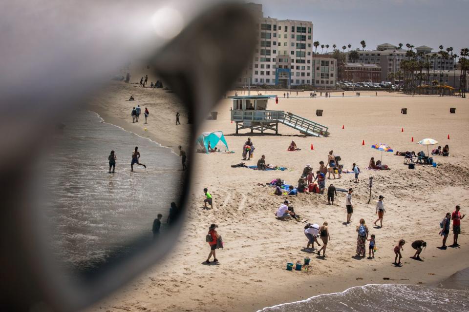 Beachgoers enjoy the first day of summer at the Santa Monica beach.