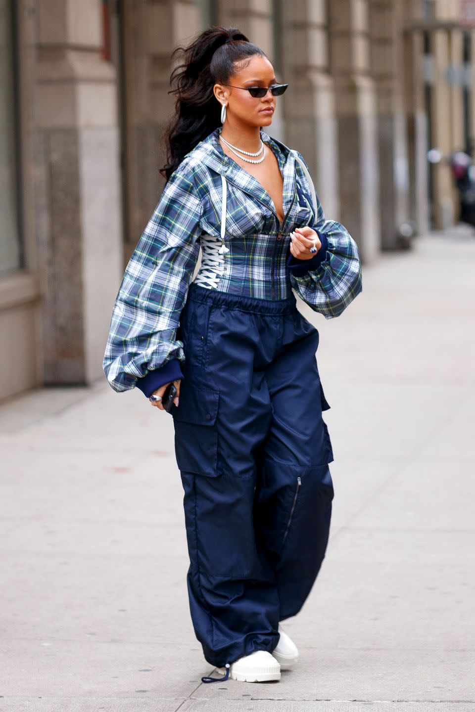 <p>In a Fenty x Puma plaid corset blouse, navy cargo pants, white creepers, Prada sunglasses, and diamond earrings and necklaces while out in NYC.</p>