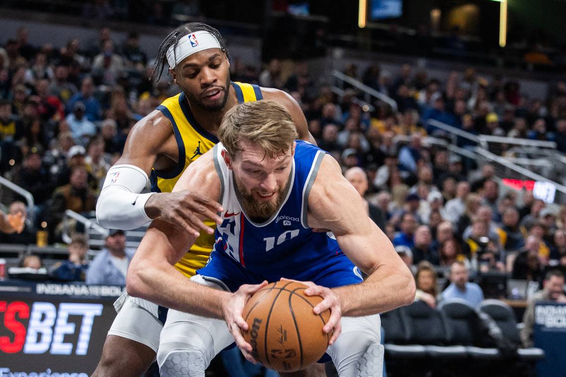 Sacramento Kings center Domantas Sabonis (10) holds the ball while Indiana Pacers guard Buddy Hield (7) defends in the second half Friday, Feb. 2, 2024, at Gainbridge Fieldhouse in Indianapolis, Indiana.