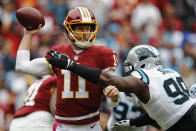 Washington Redskins quarterback Alex Smith (11) passes the ball under pressure from Carolina Panthers defensive tackle Kawann Short (99) during the first half of an NFL football game, Sunday, Oct. 14, 2018, in Landover, Md. (AP Photo/Patrick Semansky)