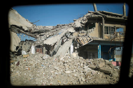 A destroyed house is seen through a car window in the eastern side of Mosul, Iraq March 9, 2017. REUTERS/Suhaib Salem