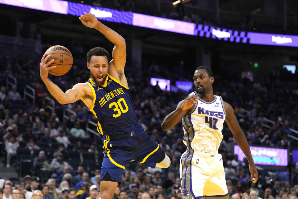 Golden State Warriors guard Stephen Curry (30) reacts after being fouled by Sacramento Kings forward Harrison Barnes (40) during the first half of an NBA basketball game on Sunday, Oct. 23, 2022 in San Francisco. (AP Photo/ Tony Avelar)