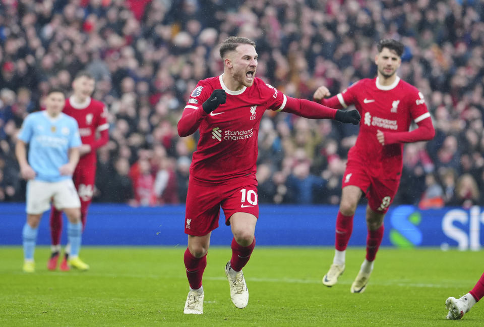 Liverpool's Alexis Mac Allister celebrates after scoring a penalty, his side's first goal during the English Premier League soccer match between Liverpool and Manchester City, at Anfield stadium in Liverpool, England, Sunday, March 10, 2024. (AP Photo/Jon Super)