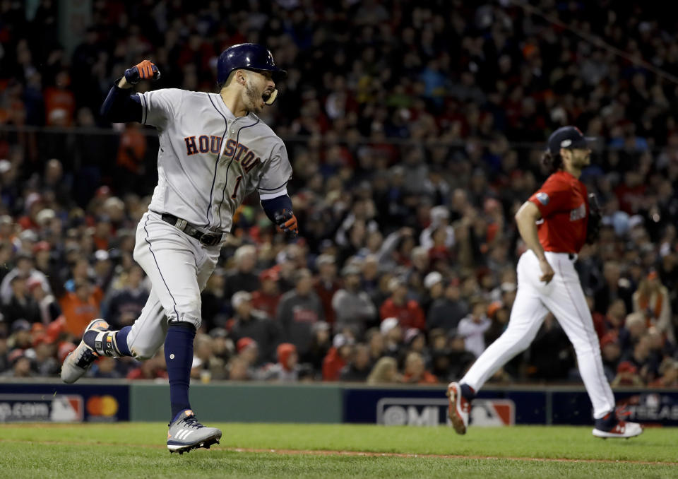 Houston Astros' Carlos Correa celebrates after his RBI-single against the Boston Red Sox during the sixth inning in Game 1 of a baseball American League Championship Series on Saturday, Oct. 13, 2018, in Boston. (AP Photo/David J. Phillip)
