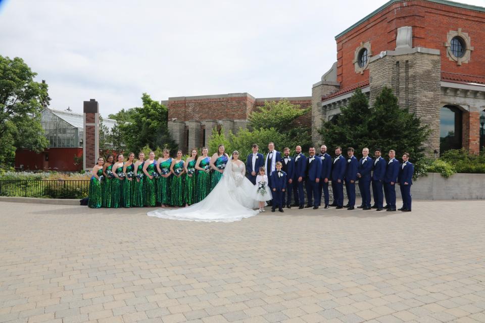 Kasey Rae Lusch and Zachary Luis Rymski are shown with their wedding party.