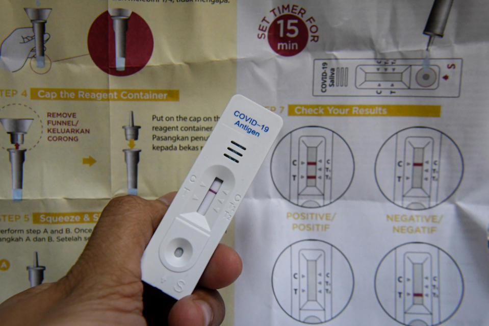 A negative result is shown after a 15-minute wait from the use of the Korean-made GMate Covid-19 Ag Saliva Home Kit, which can now be purchased at a CareMax Pharmacy in Setapak. — Bernama pic