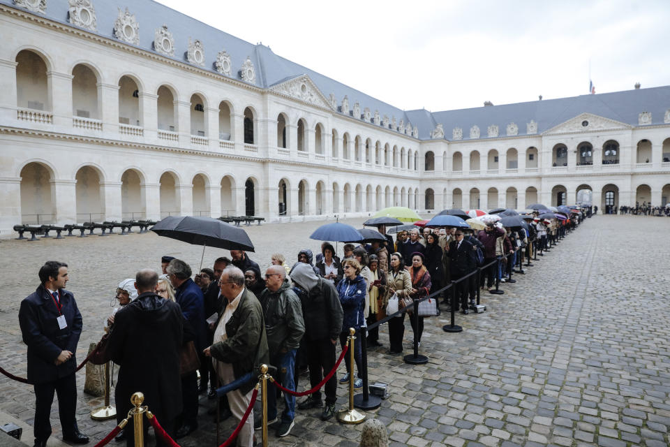 Visitors queue to pay their respects to former French President Jacques Chirac, Sunday, Sept. 29, 2019 at the Invalides monument in Paris. Jacques Chirac will lie in state Sunday during a public ceremony at the Invalides monument, where France honors its heroes. A memorial service and private funeral are planned for Monday. (AP Photo/Kamil Zihnioglu, Pool)