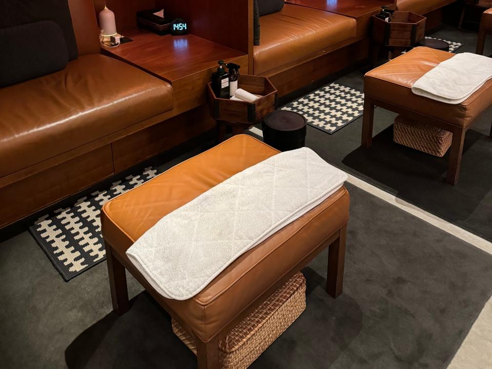 The massage suite at Cathay Pacific's The Pier, a first- class lounge at Hong Kong International Airport. It has dark, relaxing lighting and tan leather accents.