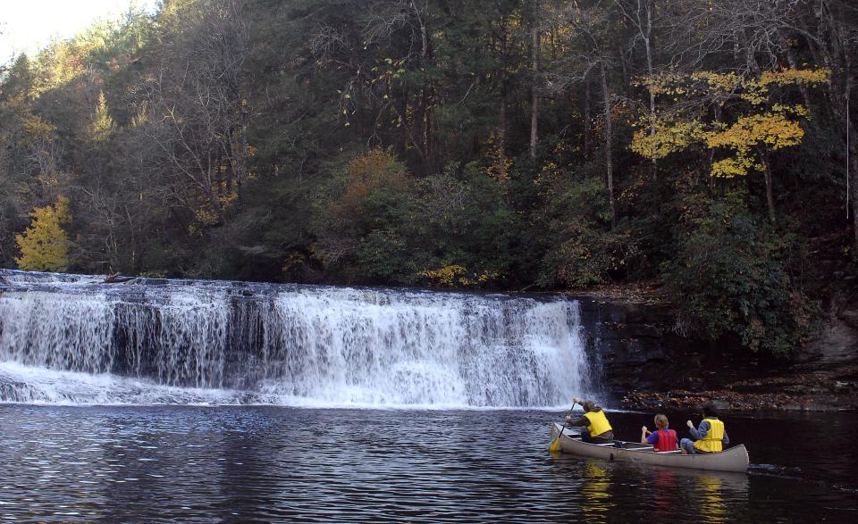 People canoe up to Hooker Falls in DuPont State Forest in this file photo.