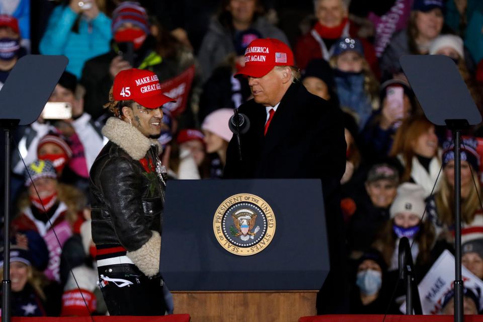 US President Donald Trump invites rapper Lil Pump on stage during his final Make America Great Again rally of the 2020 US Presidential campaign at Gerald R. Ford International Airport on November 2, 2020, in Grand Rapids, Michigan. (Photo by JEFF KOWALSKY / AFP) (Photo by JEFF KOWALSKY/AFP via Getty Images)