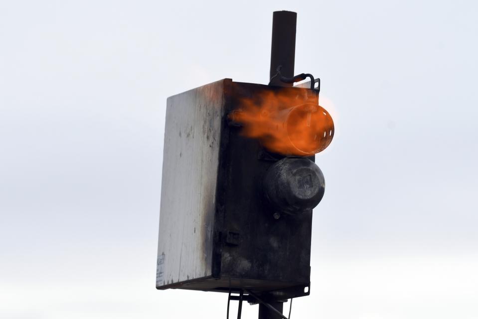 Flames ignite on a cloud seeding device near Lyons, Colo., on Thursday, March 16, 2023. The technique to get clouds to produce more snow is being used more as the Rocky Mountain region struggles with a two-decade drought. (AP Photo/Thomas Peipert)