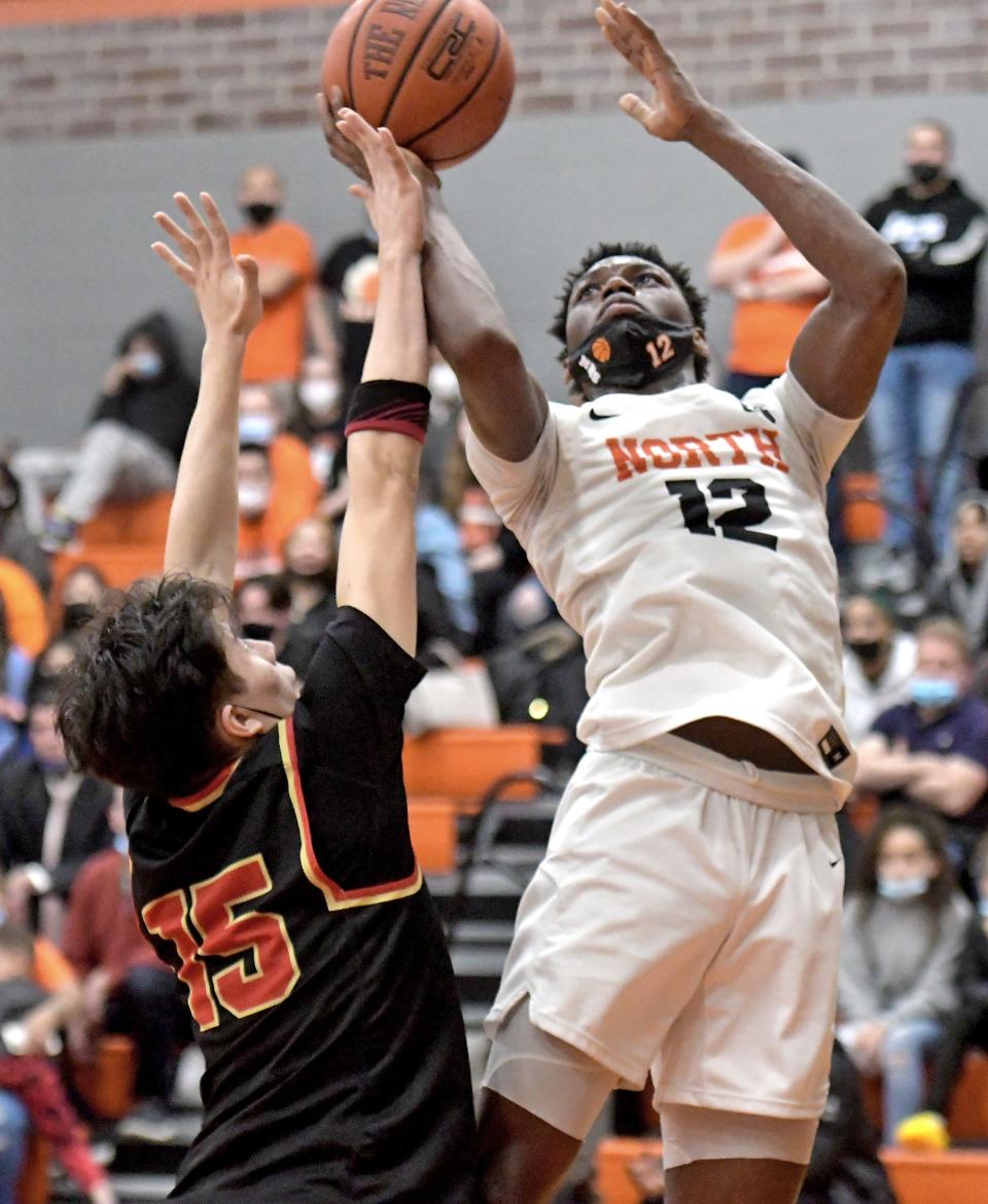 North's Joe Okla puts up a shot over Everett's Roger Vasquez during the state tournament.