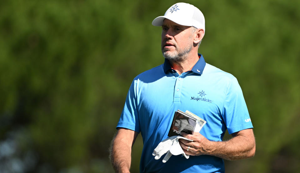  Westwood looks on whilst holding his yardage book 