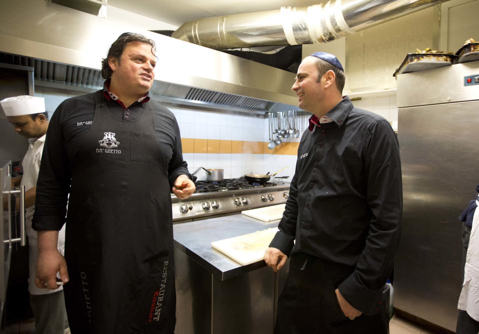 Ba'Ghetto restaurant owners Ilan Dabush, left, and his brother Amit talk in the kitchen of their restaurant, during an interview with the Associated Press, in Rome, Monday Jan. 20, 2014. For just one day, the kitchen of the Vatican hotel where Pope Francis lives went kosher, with Rabbi Jaakov Spizzichino overseeing the scrupulous cleaning of countertops, boiling of utensils and heating of the oven necessary to render it fit for cooking under Jewish dietary laws. The occasion? A four-course luncheon Francis hosted last week for a dozen Argentine rabbis. Francis was hosting Rabbi Abraham Skorka and about 15 other rabbis from Buenos Aires who came to Rome en masse to visit their old friend, and the Vatican pulled out all the stops. Organizers turned to Ba'Ghetto, one of the best kosher restaurants in Rome's ghetto on the other side of the Tiber River, to cater the affair. "I decided to do it simple, because the pope is simple," said Amit Dabush, Ba'Ghetto's Israeli-born co-owner. "But the menu was full: He had to make a 'bella figura,'" or a good impression on his guests. (AP Photo/Alessandra Tarantino)