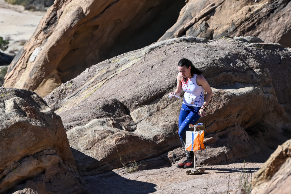TeamUSA Elite Squad member Alison Crocker (OR) slows briefly to interpret the complex rock detail of Vasquez Rocks Natural Area (Agua Dulce, CA). Alison would go on to win this Women's Elite course to be crowned US Middle Distance Champion for 2022.<span class="copyright">Orienteering USA</span>