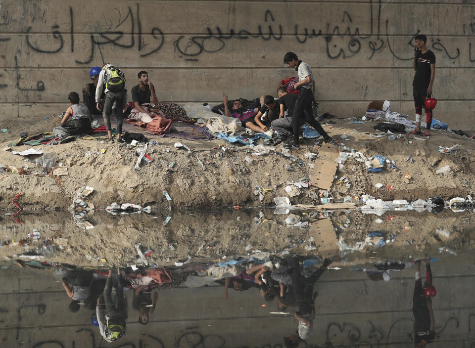Protesters rest under the Joumhouriya Bridge, that leads to the Green Zone where many government offices and embassies are located, during ongoing anti-government protests, in Baghdad, Iraq, Sunday, Nov. 3, 2019. (AP Photo/Hadi Mizban)