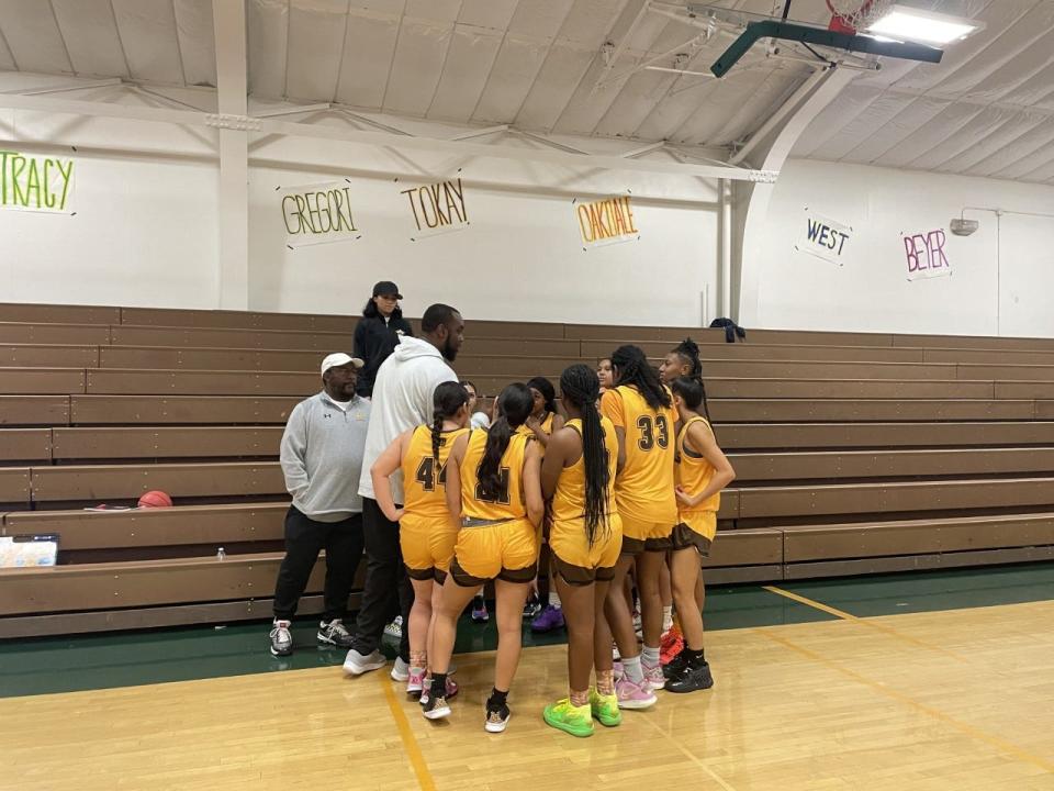 Stagg girls basketball players hear from their coaches during a team huddle ahead of their game against West High School on Thursday, Dec. 29, 2022.