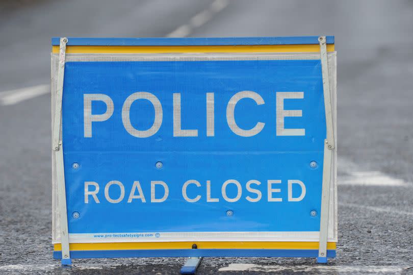 Police road closed sign