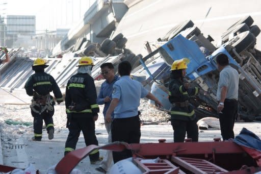 Police investigate a collapsed eight-lane suspension bridge in Harbin, China, on August 24, 2012. Three people were killed and five injured when an eight-lane suspension bridge in northeast China collapsed early on August 24, only nine months after it opened, state media said