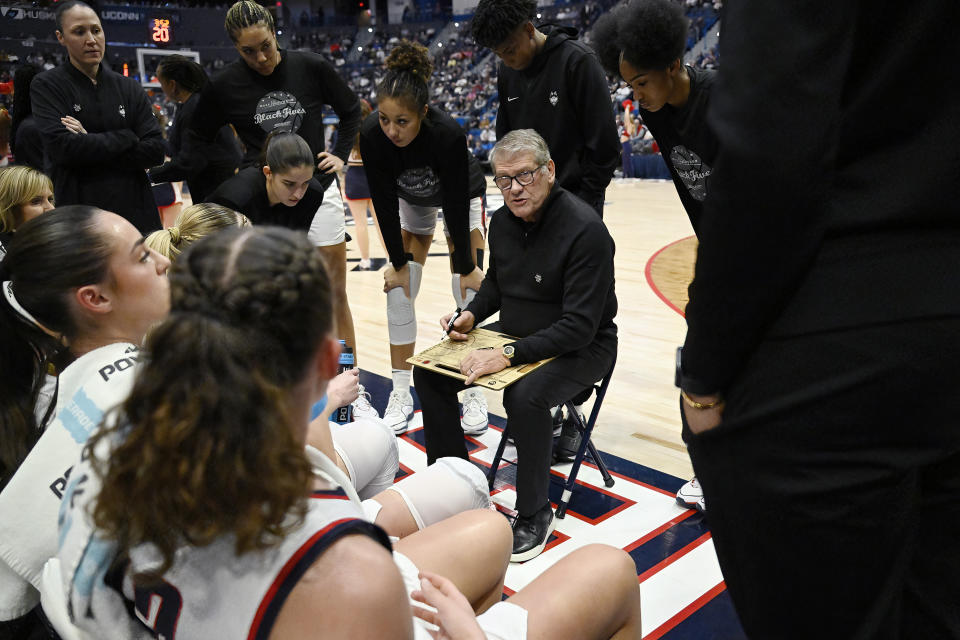 UConn head coach Geno Auriemma talks with his players during a timeout in the first half of an NCAA college basketball game against Seton Hall, Wednesday, Feb. 7, 2024, in Hartford, Conn. (AP Photo/Jessica Hill)