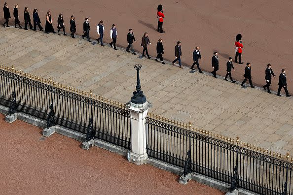 LONDON, ENGLAND - SEPTEMBER 19: Buckingham Palace household staff pay their respects during the State Funeral of Queen Elizabeth II on September 19, 2022 in London, England. Elizabeth Alexandra Mary Windsor was born in Bruton Street, Mayfair, London on 21 April 1926. She married Prince Philip in 1947 and ascended the throne of the United Kingdom and Commonwealth on 6 February 1952 after the death of her Father, King George VI. Queen Elizabeth II died at Balmoral Castle in Scotland on September 8, 2022, and is succeeded by her eldest son, King Charles III.  (Photo by Chip Somodevilla/Getty Images)