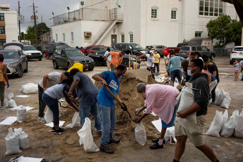 FILE PHOTO: Residents fill sandbags, provided by Mayor LaToya Cantrell and the local government, as Hurricane Laura warnings have been issued, in New Orleans