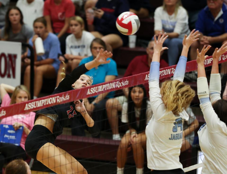 Assumption's Chloe Smith (23) goes for a kill shot against Mercy during their match at the Assumption High School gym in Louisville, Ky. on Sept., 2022.  Assumption won 3-1.