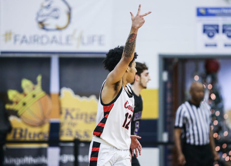 George Rogers Clark's Sam Parrish signals his three-point shot is good as the Cardinals defeated Male 70-59 at Saturday's King of the Bluegrass in Fairdale. Dec. 17, 2022