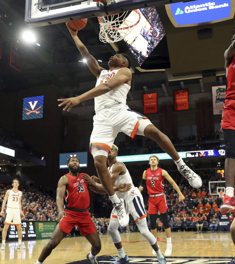 Virginia guard Casey Morsell (13) shoots over Stony Brook defenders during an NCAA college basketball game in Charlottesville, Va., Wednesday, Dec. 18, 2019. Virginia won 56-44. (AP Photo/Andrew Shurtleff)