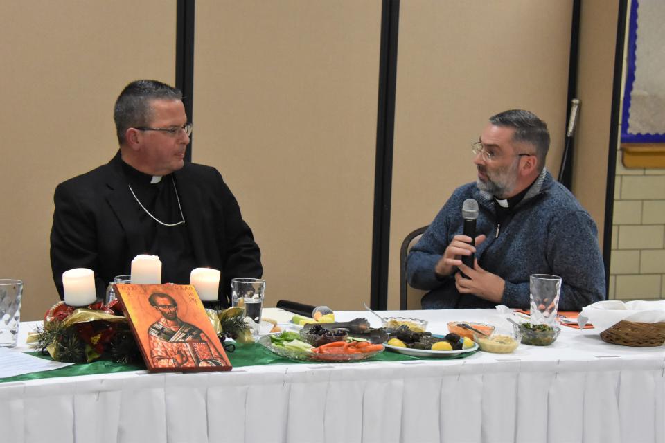 Bishop David Bonnar, head of the Catholic Diocese of Youngstown, left, speaks with the Rev. Shawn Conoboy, who has been reassigned to the Vatican.