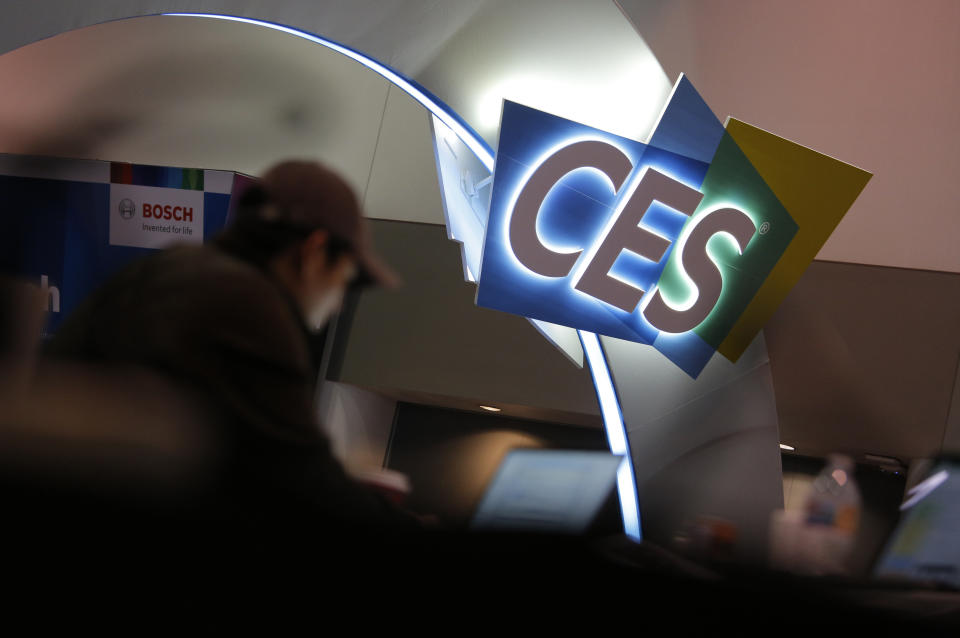 A worker helps set up a booth before CES International, Saturday, Jan. 4, 2020, in Las Vegas. (AP Photo/John Locher)