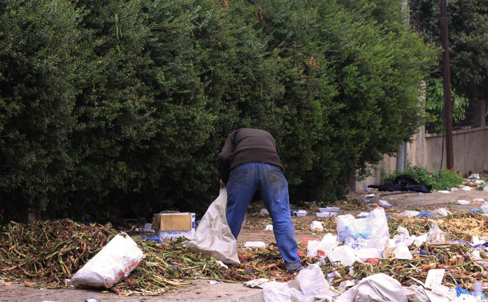 In West Mosul, Zachariyah searches for edible vegetables among trash