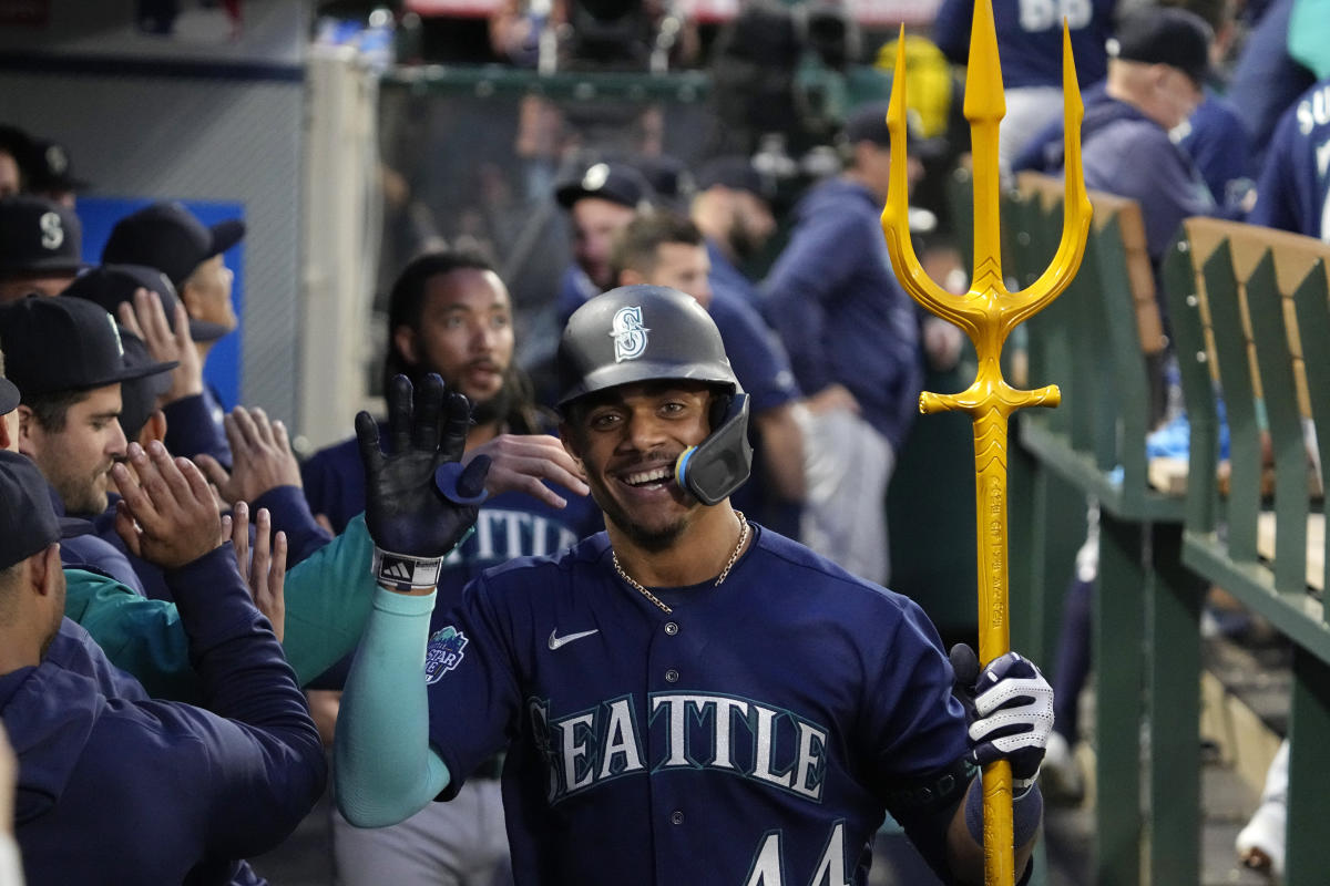 Seattle Mariners' Teoscar Hernandez in the dugout holding the trident used  for home run celebrations after his against the St. Louis Cardinals during  a baseball game, Saturday, April 22, 2023, in Seattle. (